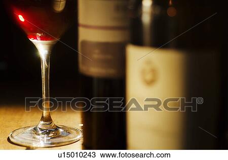 Studio shot of wine glass and bottles View Large Photo Image Stock Image - Studio shot of wine glass and bottles. Fotosearch