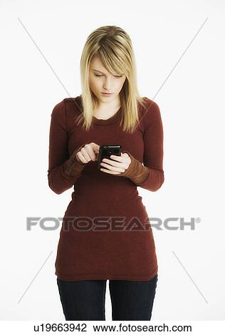 Studio shot of woman text messaging View Large Photo Image Stock Image - Studio shot of woman text messaging. Fotosearch