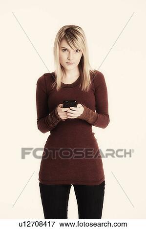 Studio shot of woman text messaging View Large Photo Image Stock Photo - Studio shot of woman text messaging. Fotosearch