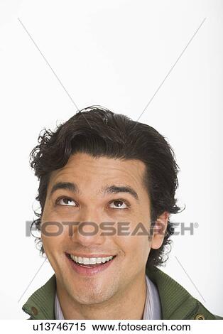 Studio shot of young man looking up View Large Photo Image Stock Photography - Studio shot of young man looking up. Fotosearch
