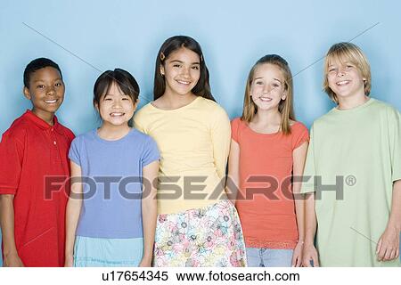 Stock Photography - Studio shot portrait of five teenagers, waist up. Fotosearch