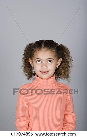 Studio shot portrait of girl looking up, waist up View Large Photo Image Stock Photography - Studio shot portrait of girl looking up, waist up. Fotosearch