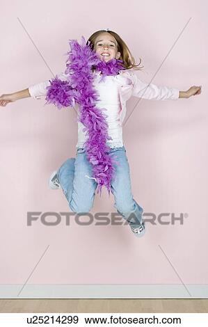 Studio shot portrait of jumping teenage girl in feather boa shawl, full length View Large Photo Image Stock Photo - Studio shot portrait of jumping teenage girl in feather boa shawl, full length. Fotosearch