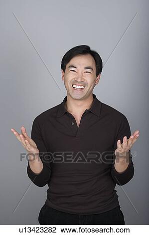 Studio shot portrait of mature man with hands raised, waist up View Large Photo Image Stock Image - Studio shot portrait of mature man with hands raised, waist up. Fotosearch