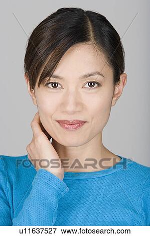 Stock Photo - Studio shot portrait of mature woman, head and shoulders. Fotosearch
