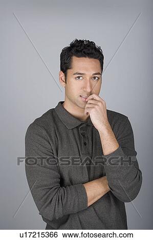 Studio shot portrait of mid adult man with finger on lips, waist up View Large Photo Image Stock Photograph - Studio shot portrait of mid adult man with finger on lips, waist up. Fotosearch
