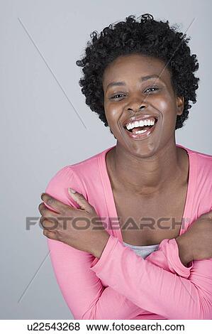 Studio shot portrait of mid adult woman with arms crossed, head and shoulders View Large Photo Image Stock Photo - Studio shot portrait of mid adult woman with arms crossed, head and shoulders. Fotosearch