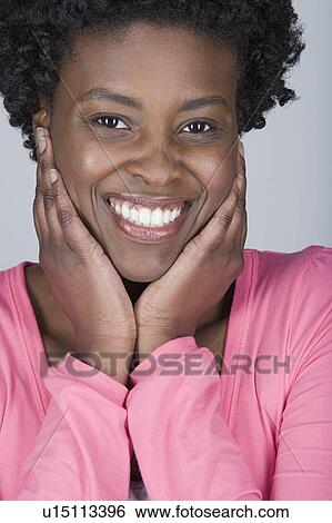 Studio shot portrait of mid adult woman with hands on chin, head and shoulders View Large Photo Image Stock Photograph - Studio shot portrait of mid adult woman with hands on chin, head and shoulders. Fotosearch