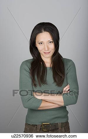 Studio shot portrait of mid adult woman with arms crossed, waist up View Large Photo Image Stock Photograph - Studio shot portrait of mid adult woman with arms crossed, waist up. Fotosearch
