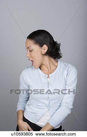 Stock Photography - Studio shot portrait of mid adult woman dancing with open mouth, waist up. Fotosearch