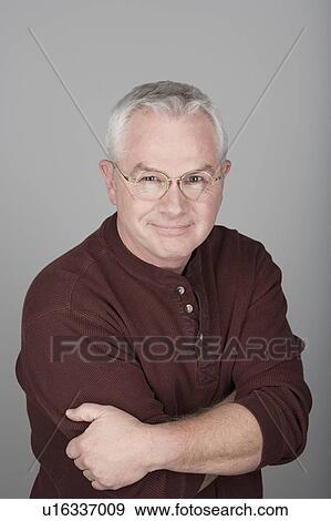 Studio shot portrait of senior man with arms crossed, head and shoulders View Large Photo Image Stock Photo - Studio shot portrait of senior man with arms crossed, head and shoulders. Fotosearch