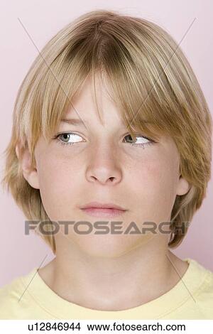 Picture - Studio shot portrait of teenage boy looking away, close-up. Fotosearch