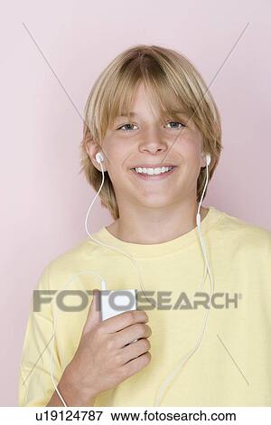 Studio shot portrait of teenage boy with mp3 player, head and shoulders View Large Photo Image Stock Photo - Studio shot portrait of teenage boy with mp3 player, head and shoulders. Fotosearch