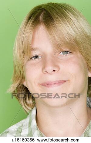 Stock Photograph - Studio shot portrait of teenage boy, close-up. Fotosearch