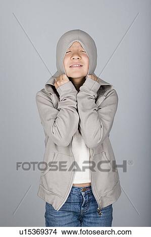 Studio shot portrait of teenage girl in hooded shirt, waist up View Large Photo Image Picture - Studio shot portrait of teenage girl in hooded shirt, waist up. Fotosearch