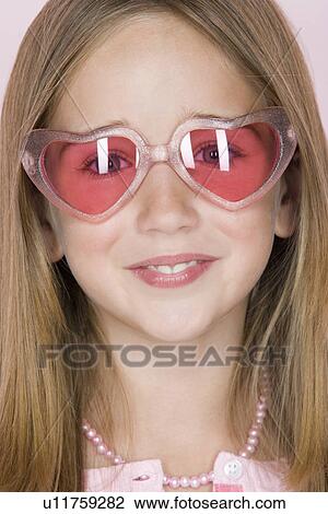 Studio shot portrait of teenage girl in pink sunglasses, close-up View Large Photo Image Stock Image - Studio shot portrait of teenage girl in pink sunglasses, close-up. Fotosearch
