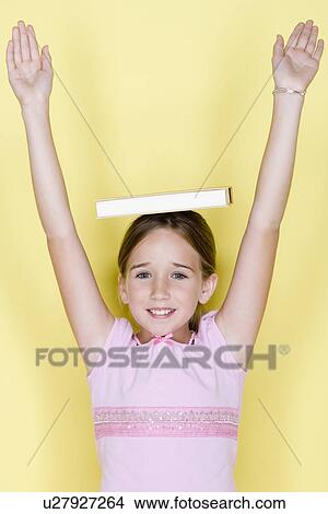 Studio shot portrait of teenage girl with arms raised, waist up View Large Photo Image Picture - Studio shot portrait of teenage girl with arms raised, waist up. Fotosearch