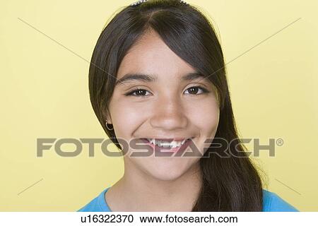 Stock Image - Studio shot portrait of teenage girl, close-up. Fotosearch