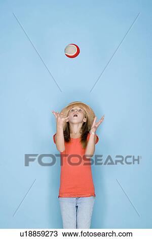 Studio shot portrait of teenage girl throwing ball, three quarter length View Large Photo Image Stock Image - Studio shot portrait of teenage girl throwing ball, three quarter length. Fotosearch