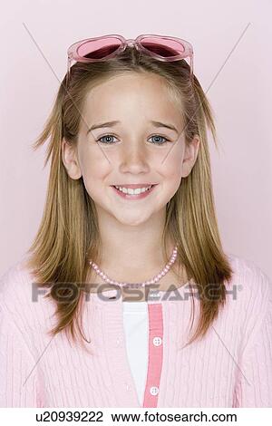 Stock Image - Studio shot portrait of teenage girl, head and shoulders. Fotosearch