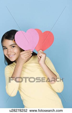 Studio shot portrait of teenage girl holding harts, waist up View Large Photo Image Stock Image - Studio shot portrait of teenage girl holding harts, waist up. Fotosearch