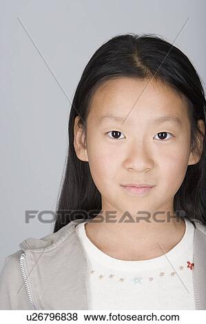 Stock Photo - Studio shot portrait of teenage girl, head and shoulders. Fotosearch