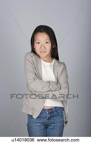 Studio shot portrait of teenage girl with arms crossed, waist up View Large Photo Image Stock Photograph - Studio shot portrait of teenage girl with arms crossed, waist up. Fotosearch