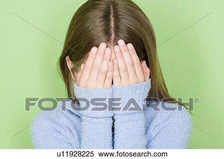 Stock Photography - Studio shot portrait of teenage girl covering face, head and shoulders. Fotosearch