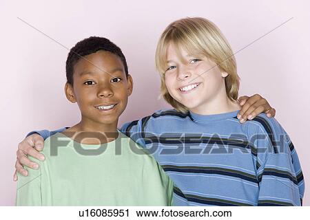 Studio shot portrait of two teenagers with arms around, head and shoulders View Large Photo Image Stock Image - Studio shot portrait of two teenagers with arms around, head and shoulders. Fotosearch