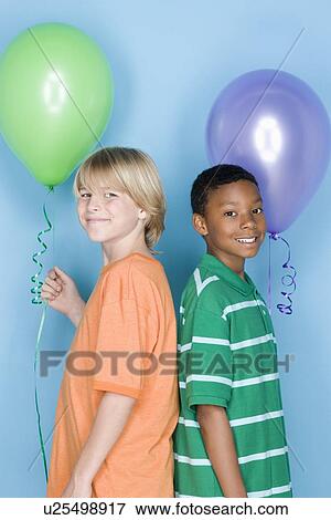 Studio shot portrait of two teenagers with balloons, waist up View Large Photo Image Stock Photo - Studio shot portrait of two teenagers with balloons, waist up. Fotosearch