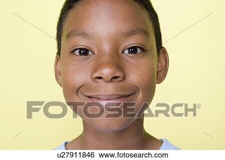 Stock Photograph - Studio shot portrait of young adult man, close-up. Fotosearch