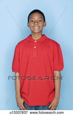 Studio shot portrait of young man in polo shirt, waist up View Large Photo Image Stock Photo - Studio shot portrait of young man in polo shirt, waist up. Fotosearch