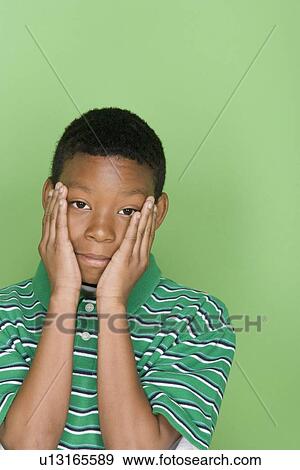 Studio shot portrait of young man with head in hands, head and shoulders View Large Photo Image Stock Photo - Studio shot portrait of young man with head in hands, head and shoulders. Fotosearch