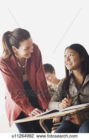 Teacher checking girl's homework View Large Photo Image Stock Image - Teacher checking girl's homework. Fotosearch