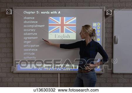 Teacher giving instructions at digital board View Large Photo Image Stock Image - Teacher giving instructions at digital board. Fotosearch
