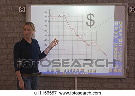 Stock Photo - Teacher giving instructions at digital board. Fotosearch
