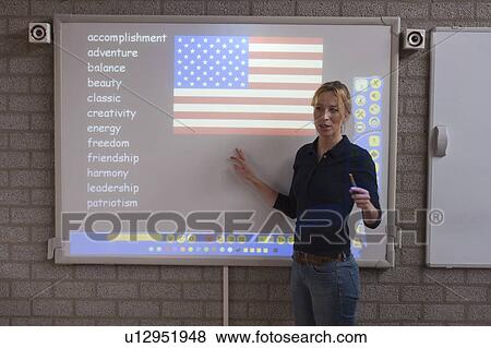 Teacher giving instructions at digital board View Large Photo Image Stock Photo - Teacher giving instructions at digital board. Fotosearch