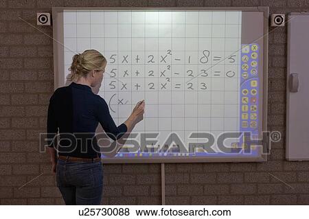 Stock Photo - Teacher giving instructions at digital board. Fotosearch