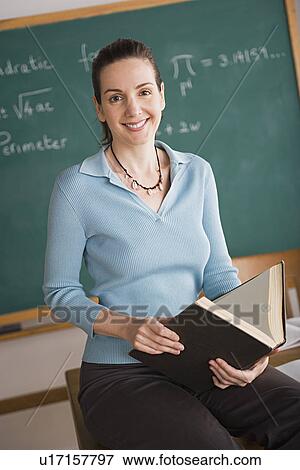 Stock Photo - Teacher in classroom during lesson. Fotosearch