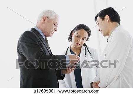 Stock Image - Three doctors discussing. Fotosearch