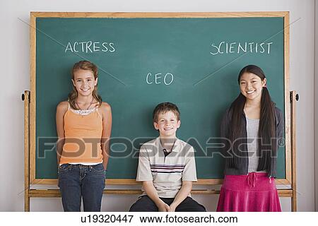 Three schoolchildren in front on blackboard View Large Photo Image Stock Photo - Three schoolchildren in front on blackboard. Fotosearch