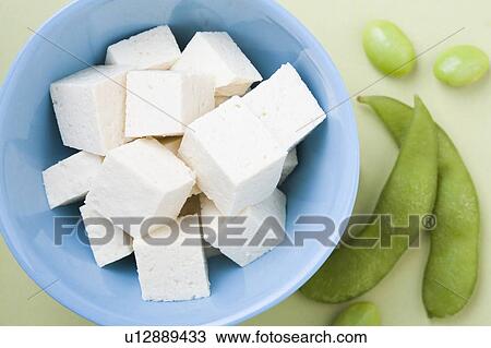 Stock Image - Tofu and edamame, studio shot. Fotosearch