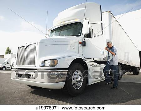 Truck driver entering truck View Large Photo Image Stock Image - Truck driver entering truck. Fotosearch