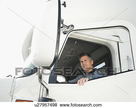 Truck driver entering truck View Large Photo Image Stock Photo - Truck driver entering truck. Fotosearch