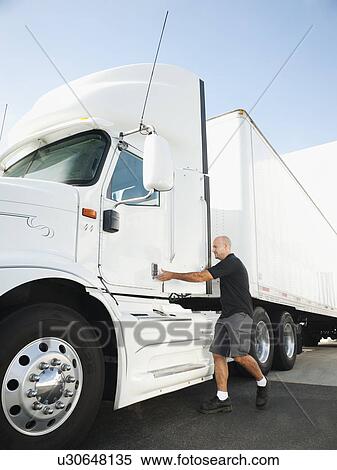 Truck driver entering truck View Large Photo Image Stock Photography - Truck driver entering truck. Fotosearch