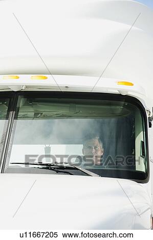 Stock Photography - Truck driver sitting in truck. Fotosearch