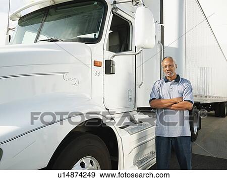 Truck driver standing near truck View Large Photo Image Stock Photo - Truck driver standing near truck. Fotosearch