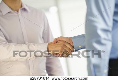 Two businessman shaking hands View Large Photo Image Picture - Two businessman shaking hands. Fotosearch
