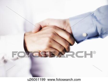 Stock Photo - Two businessman shaking hands. Fotosearch
