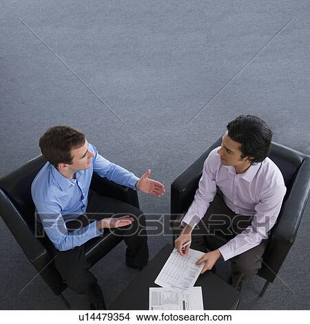 Picture - Two businessman talking. Fotosearch
